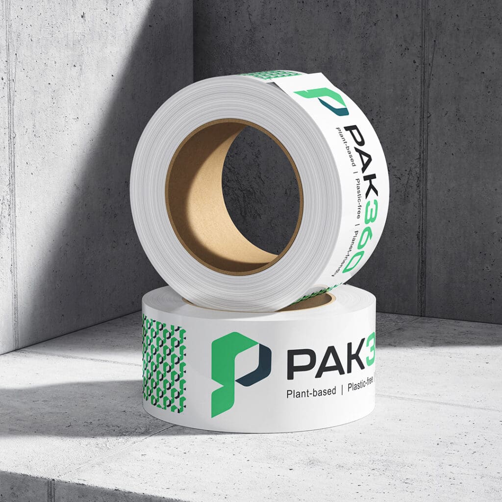 Two branded PAK360 tape rolls with eco-friendly messaging on a concrete surface.